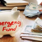 "Emergency fund piggy bank 2026 debt payoff savings guide TheWealthe.com"