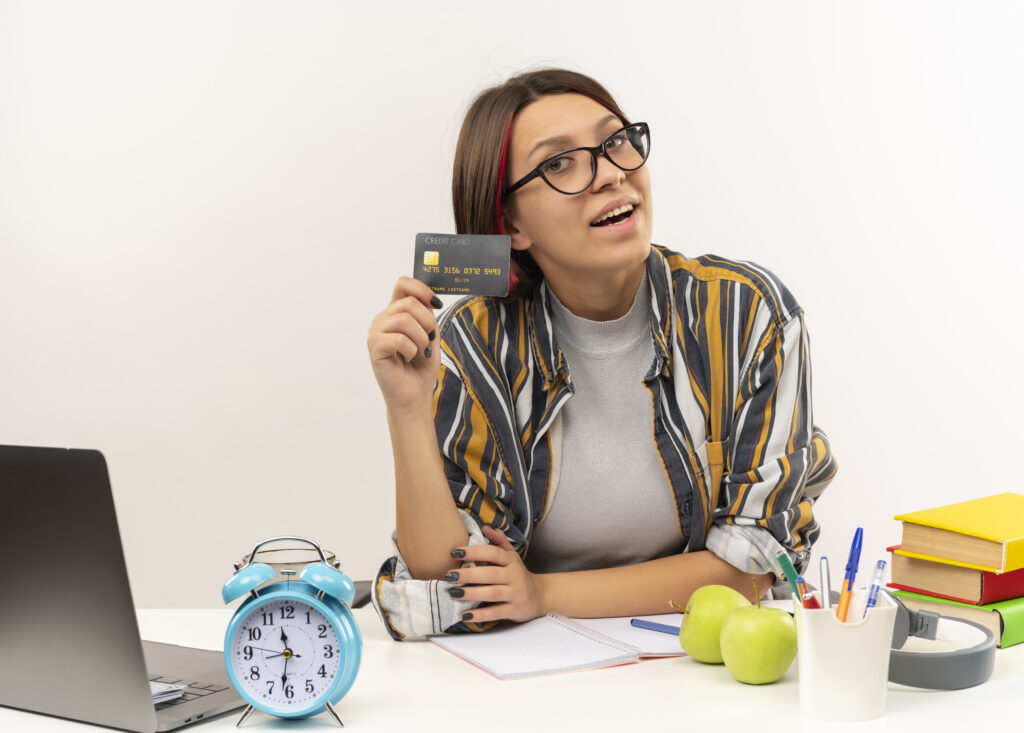 Young student girl showing credit card on white background, credit card debt payoff,